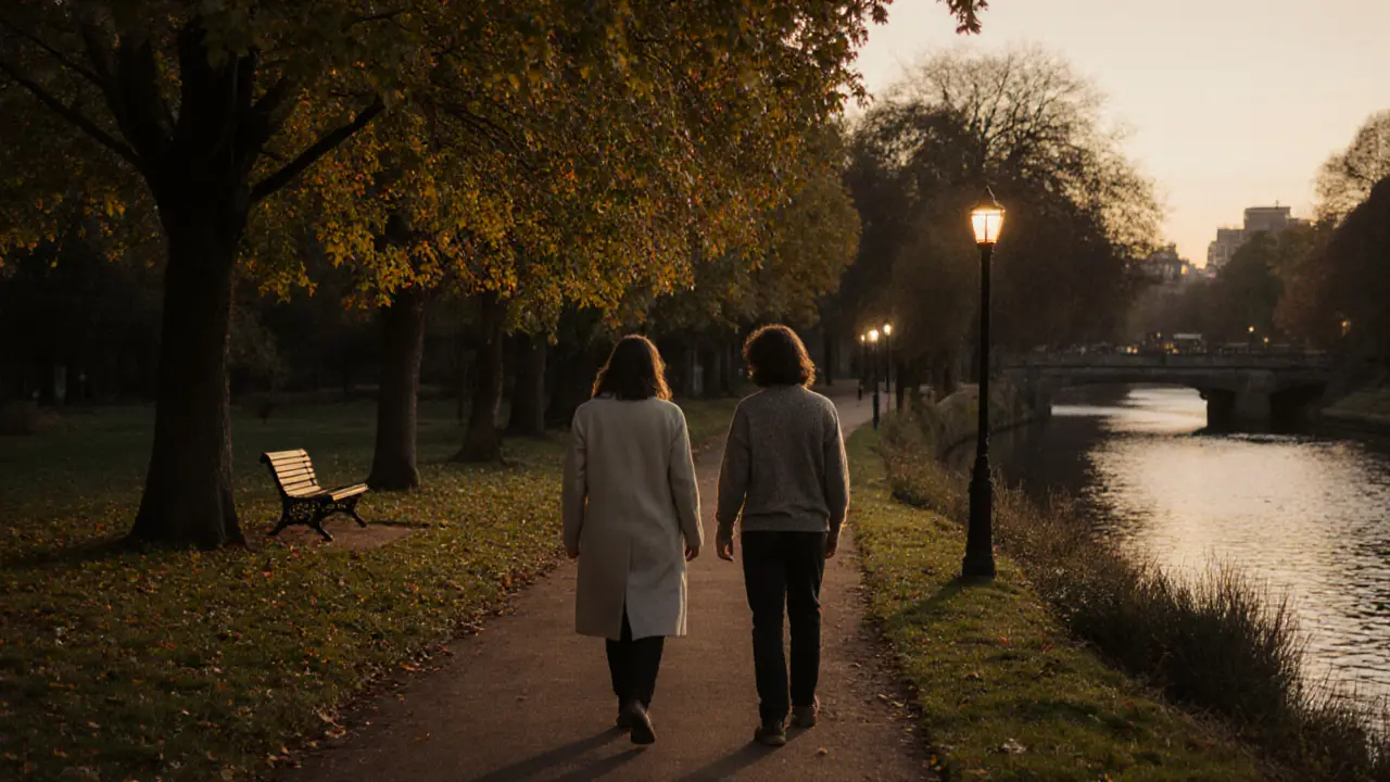 Two people walking peacefully along the River Ravensbourne at dusk, surrounded by autumn trees.