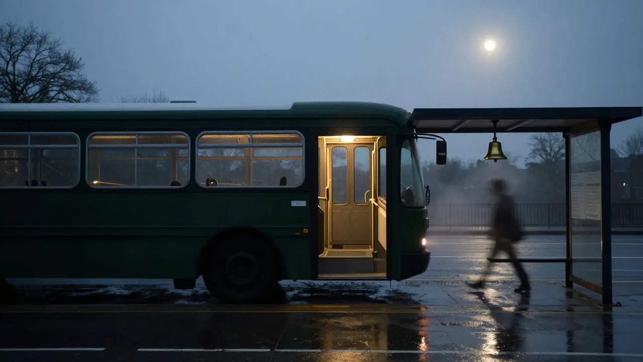 A windowless dark green bus arriving at an empty bus stop under a moonlit bridge.